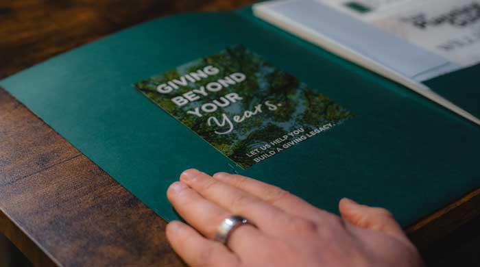 hand over a green folder